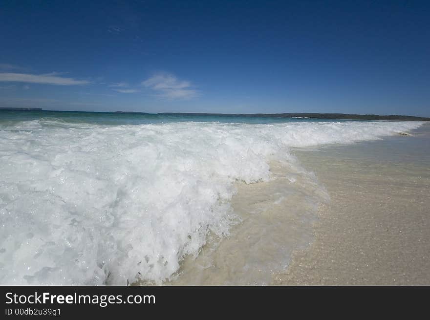 Closeup view of waves crashing on a tropical beach. Closeup view of waves crashing on a tropical beach