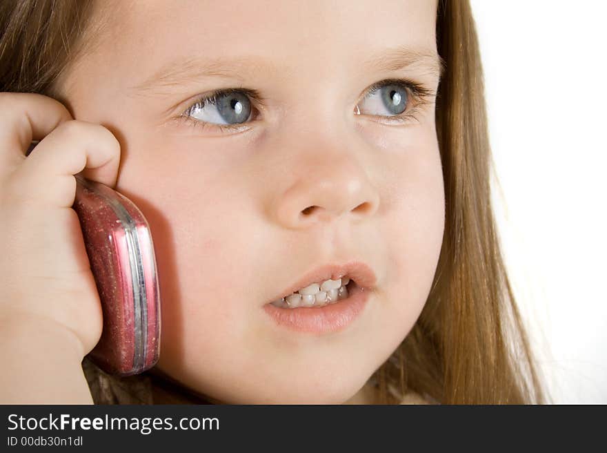 Little girl talking at red mobile phone. Little girl talking at red mobile phone