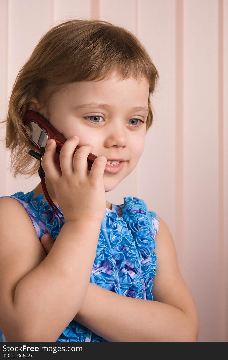 Little girl talking at phone