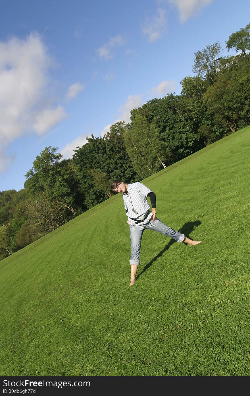 Beautiful woman playing in the grass