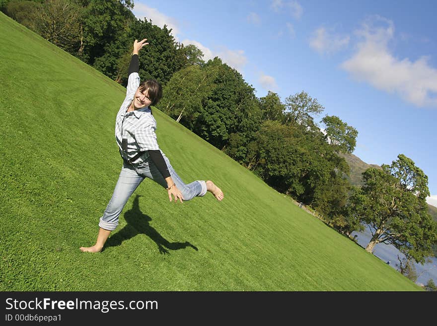 Beautiful woman playing in the grass