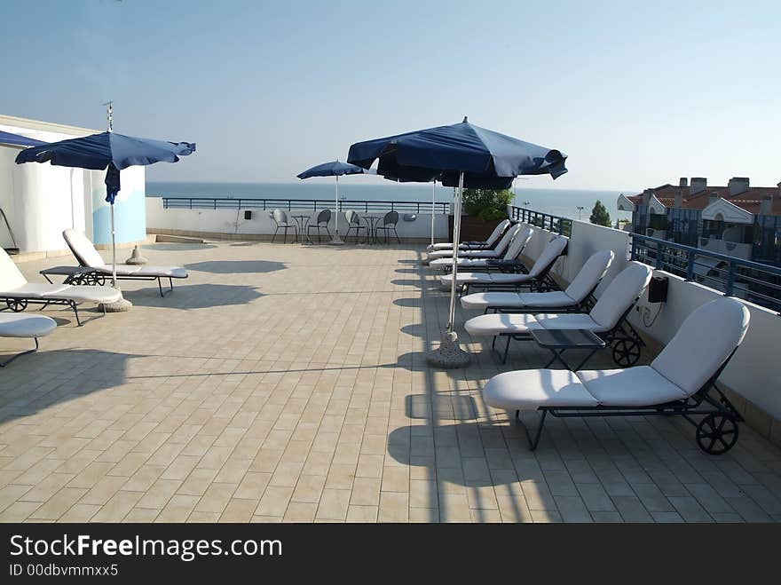 Beach scene with blue umbrellas, chairs and relax equipment. Beach scene with blue umbrellas, chairs and relax equipment