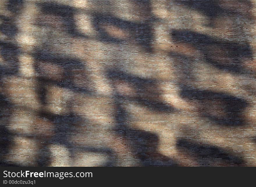 Abstract shadows on a brick wall ? reflections of windows in the sunlight.