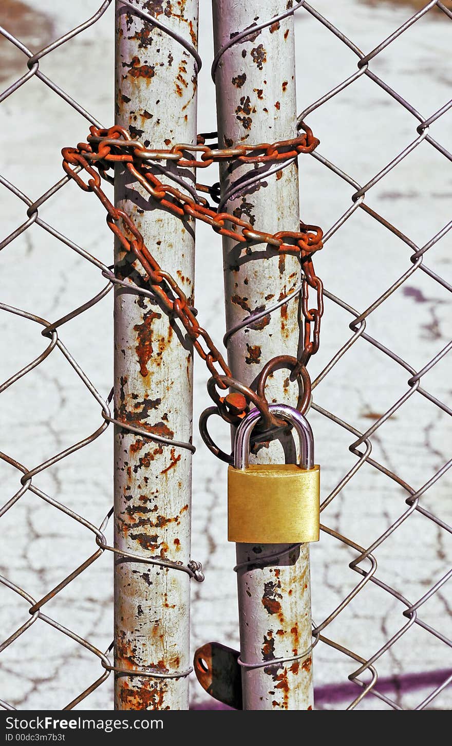 Wire fence with a rusty chain and a lock. Wire fence with a rusty chain and a lock