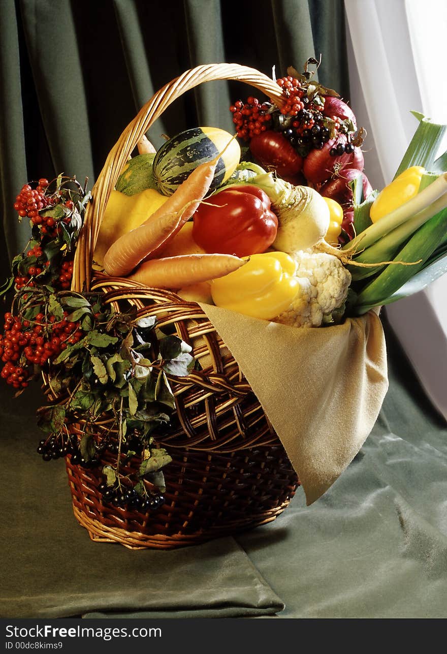 Still-life from vegetables in a basket. Still-life from vegetables in a basket