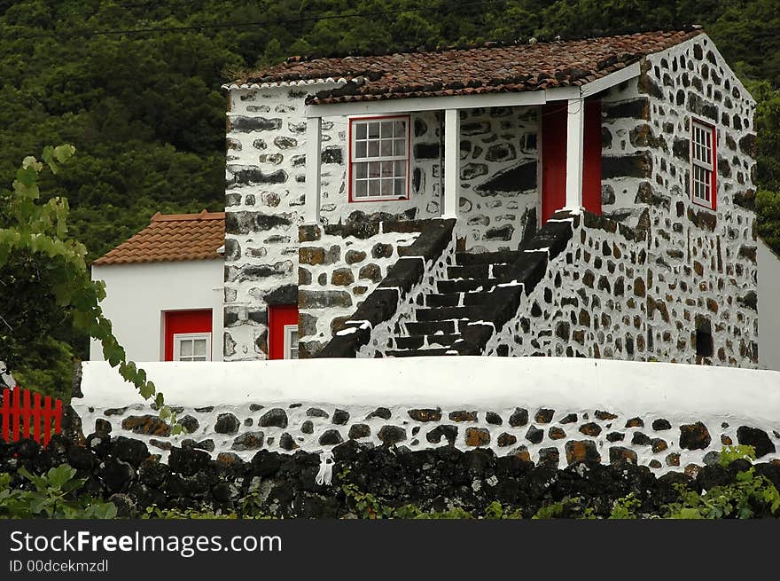 Old azores home made of stone and old ceramic roof tiles