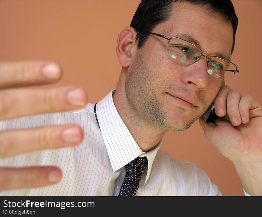 Business call.Young businessman talking to the cell phone. Business call.Young businessman talking to the cell phone.