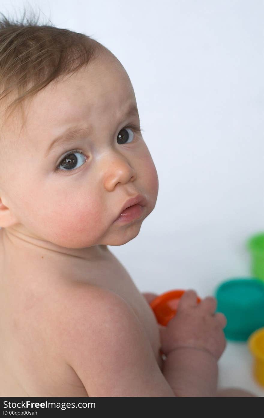 Image of adorable baby playing with stacking cups. Image of adorable baby playing with stacking cups