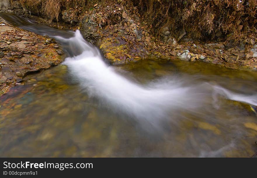 Fall at the river witn silky water.