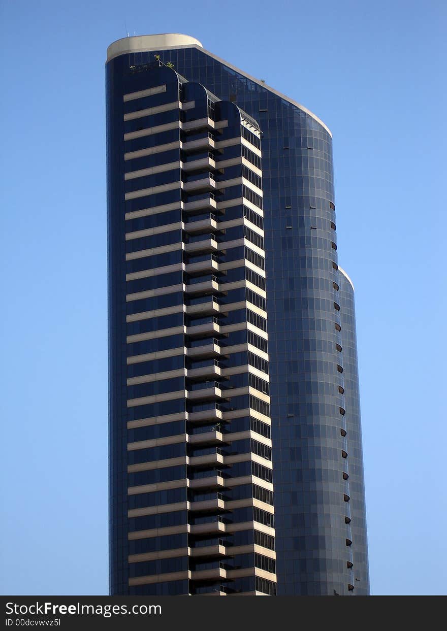 Modern skyscrapers against a bright blue sky