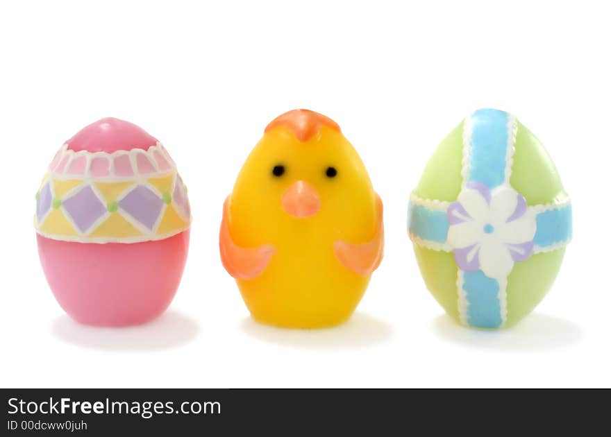 Pastel colored, wax Easter eggs on white background.