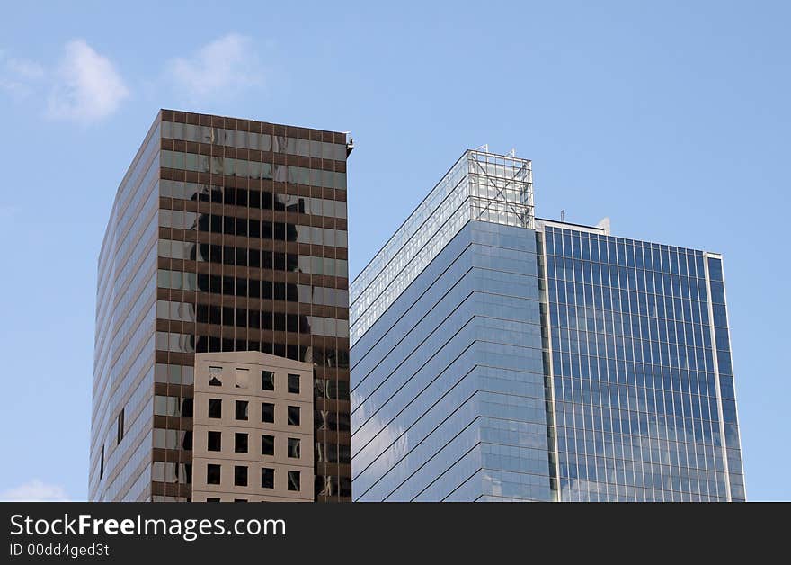 Modern skyscrapers against a bright blue sky