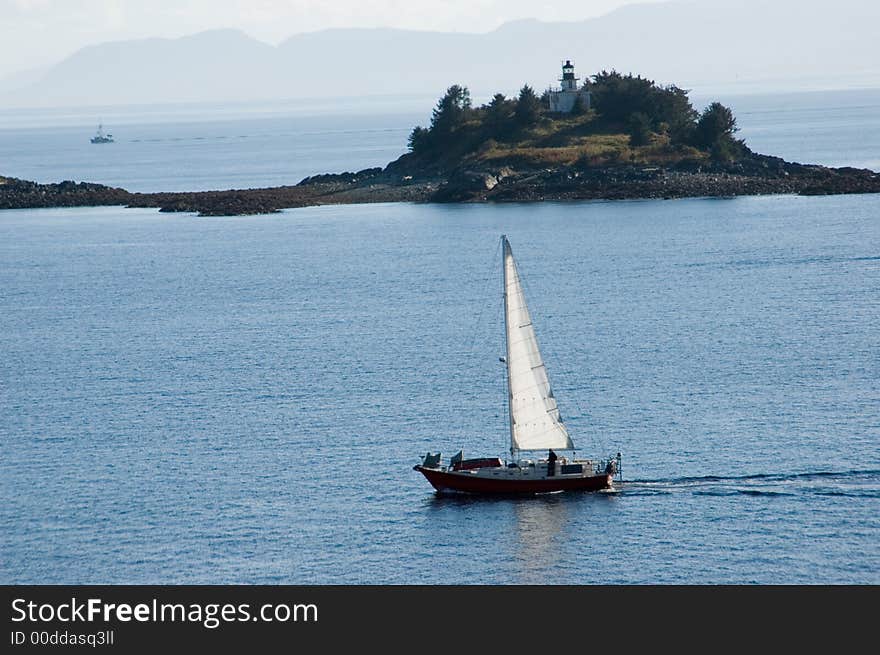 Sailboat near island lighthouse