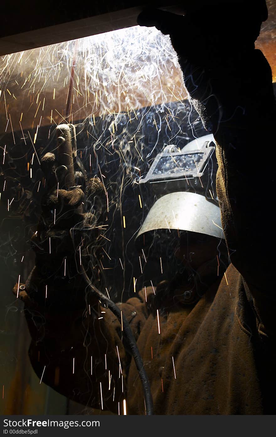 Welder at work close up from side. Welder at work close up from side