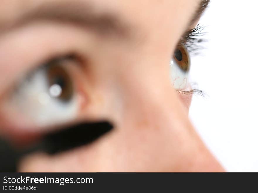 Closeup of a woman applying mascara