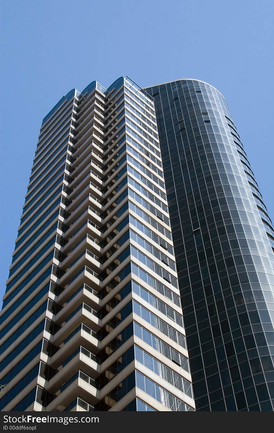 Modern skyscrapers against a bright blue sky