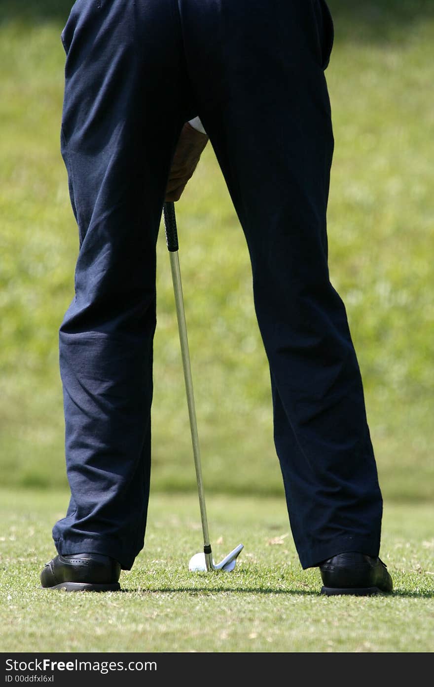 A golfer playing golf in the field.