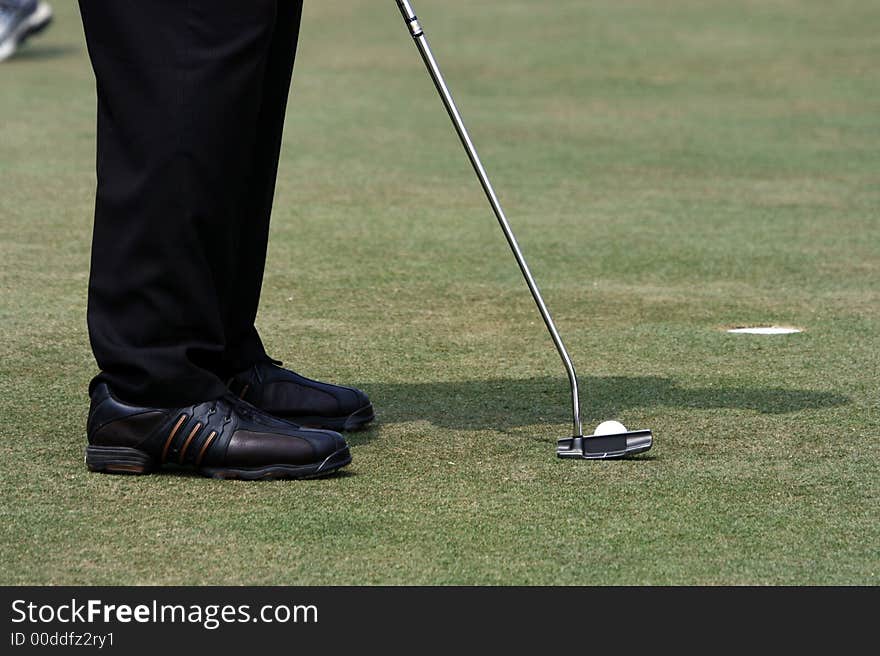 A golfer playing golf in the field.