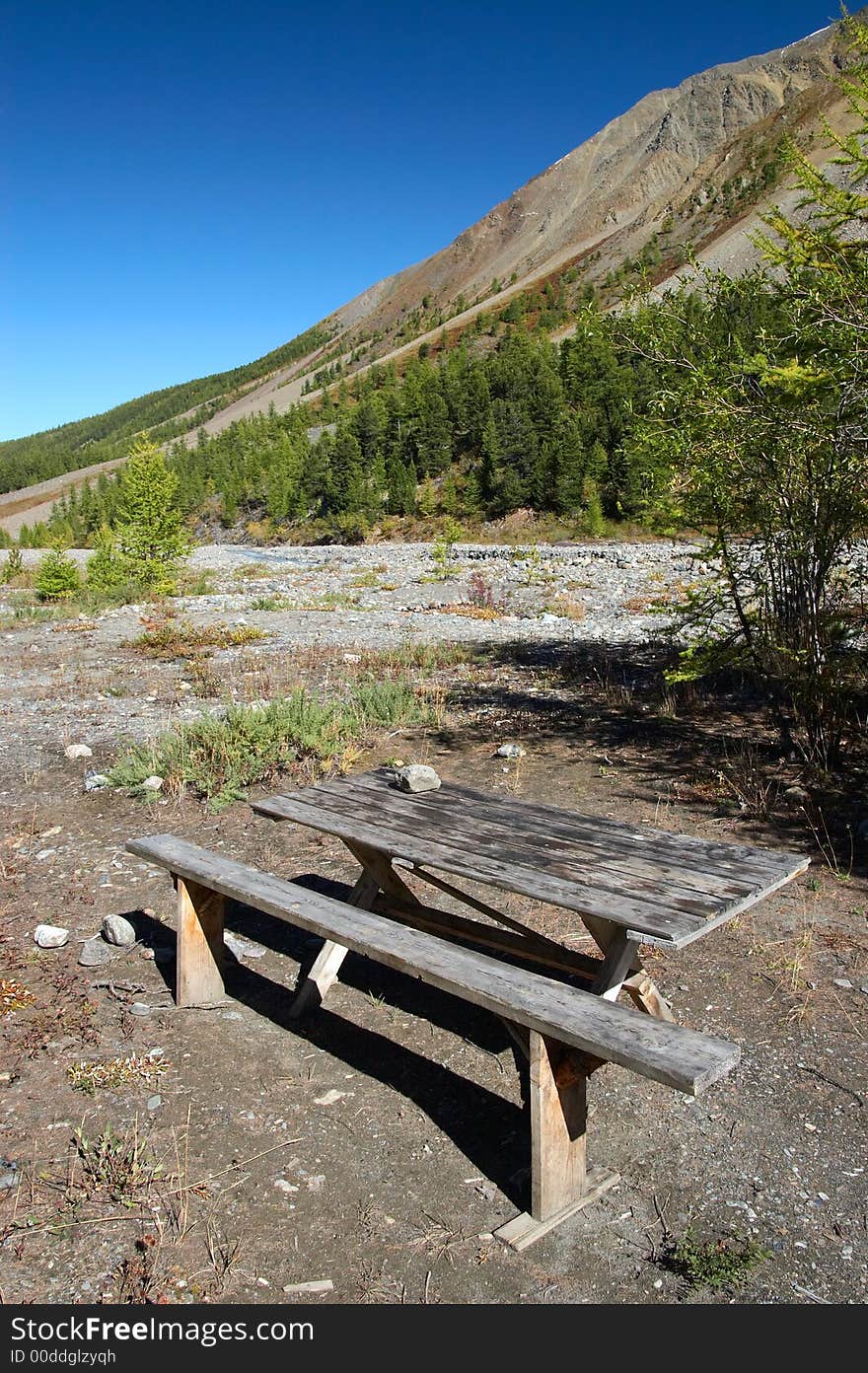 Bench, Table And Mountainside.