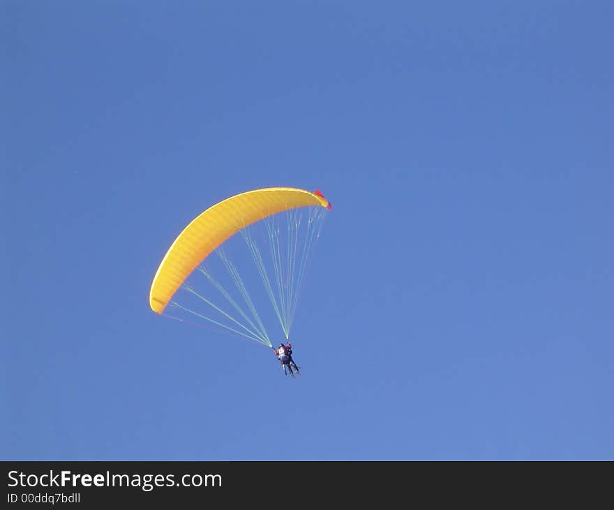 Paraglider on clear blue sky. Paraglider on clear blue sky