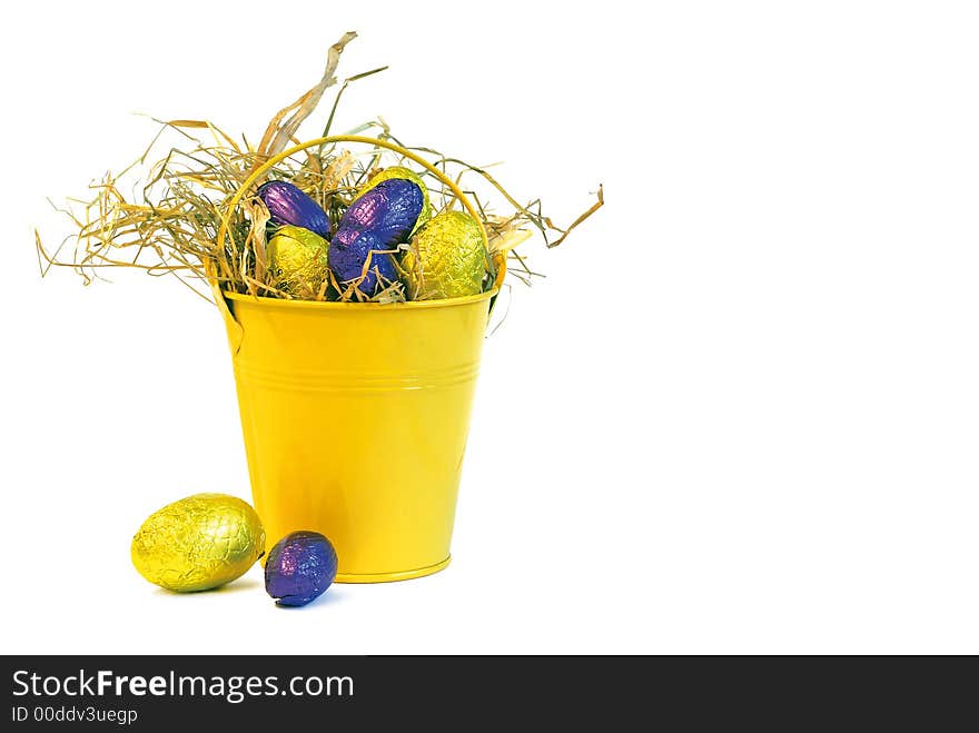 Yellow bucket with yellow and purple easter eggs. Yellow bucket with yellow and purple easter eggs