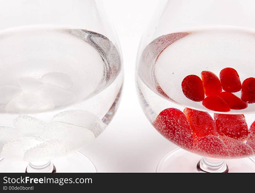 Two glasses with pebbles resembling white and red wine