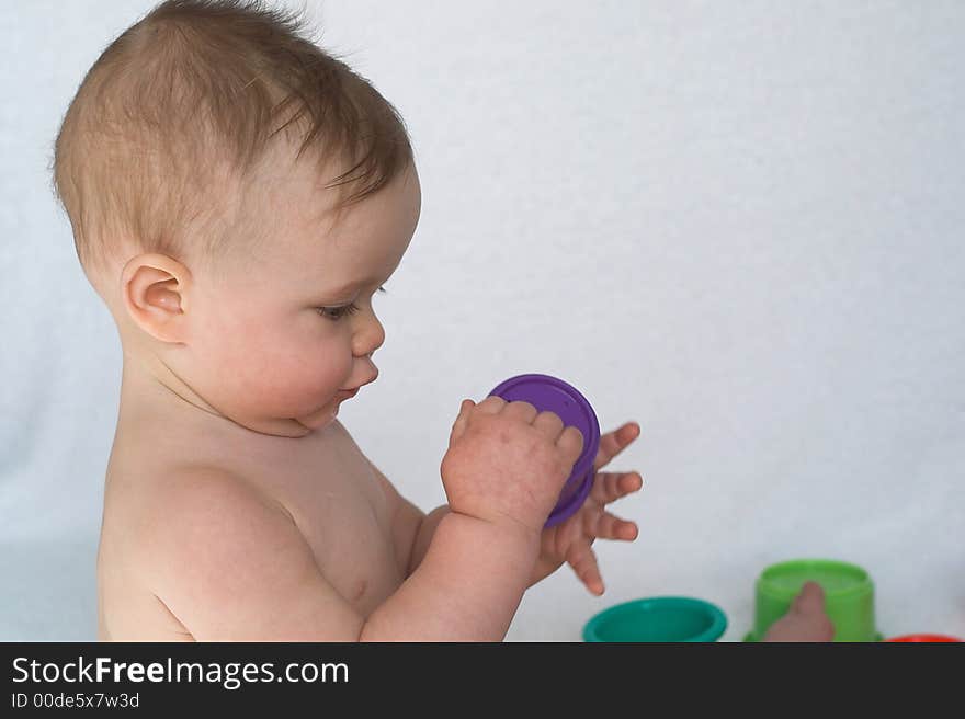 Image of adorable baby playing with stacking cups. Image of adorable baby playing with stacking cups