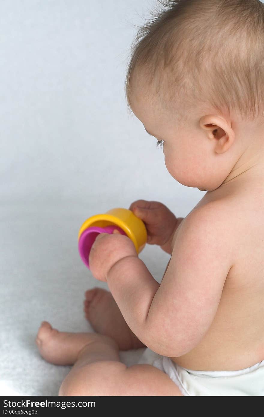 Image of adorable baby playing with stacking cups. Image of adorable baby playing with stacking cups