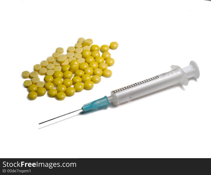 Syringe and yellow tablets