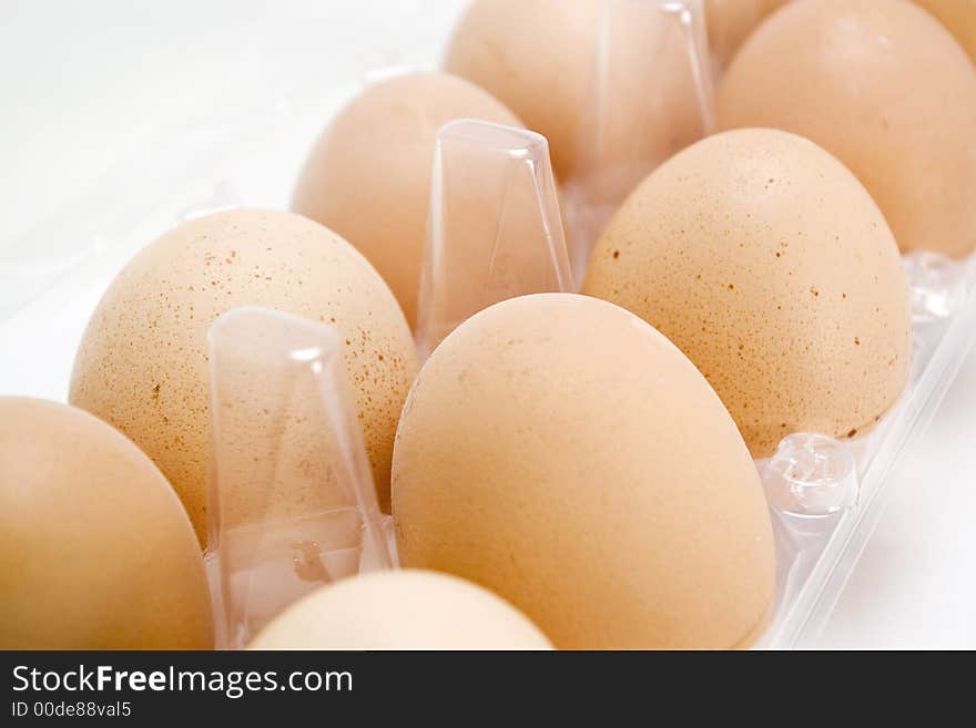 Closeup of organic fresh eggs in a plastic recipient