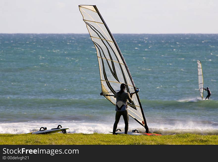 SHot of windsurfer getting ready to go in the ocean.