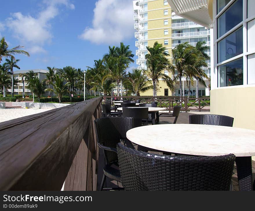 Tables and chairs outside of / at a peaceful beach front restaurant in The Bahamas islands. Tables and chairs outside of / at a peaceful beach front restaurant in The Bahamas islands