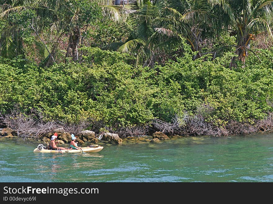 An older couple exploring the bay in a raft. An older couple exploring the bay in a raft