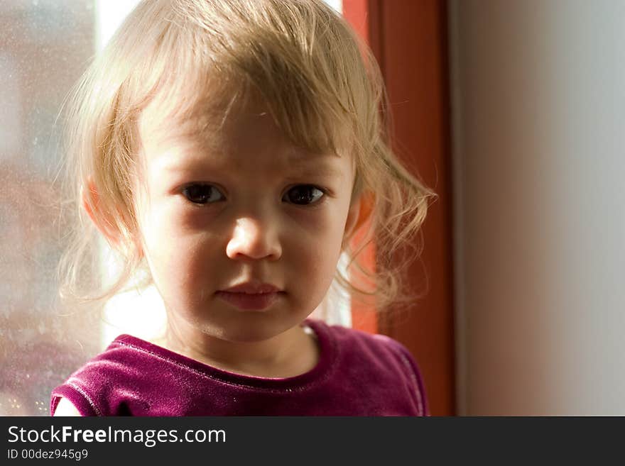 Cute little girl alight with rays of sun