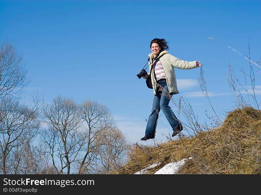 Lady Photographer Jumping With Camera