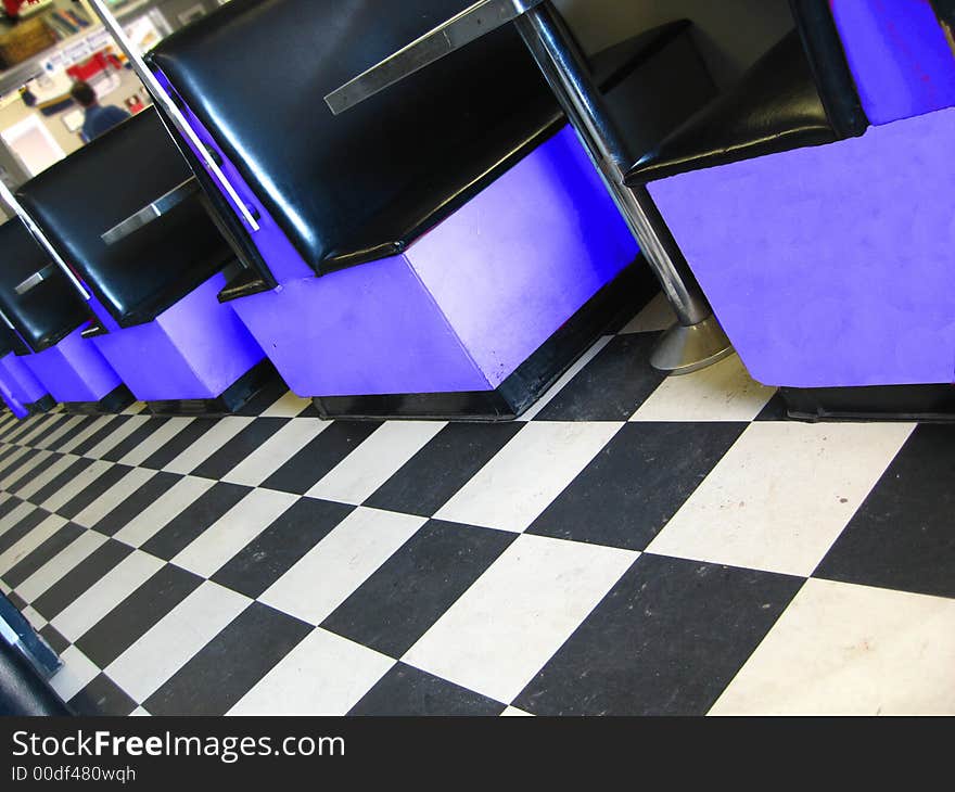 Vintage restaurant with checkerboard floor and blue booths