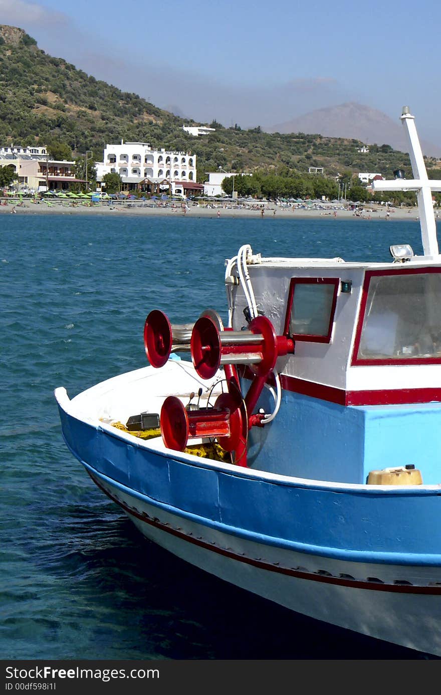 Crete colorful fishing boat with view on island. Crete colorful fishing boat with view on island