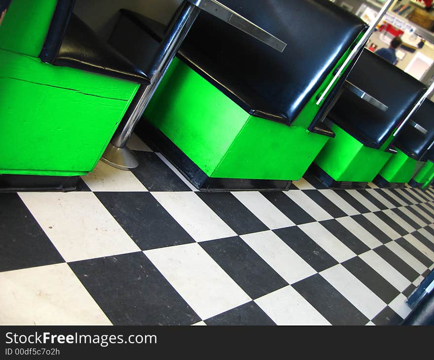 Vintage restaurant with checkerboard floor and green booths