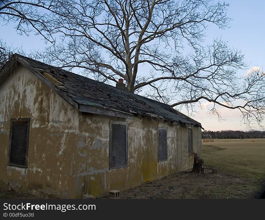 An old small farm building in ruins. An old small farm building in ruins.