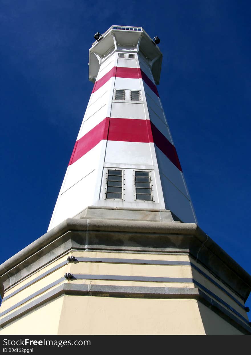 Closeup portrait of lighthouse in blue sky. Closeup portrait of lighthouse in blue sky