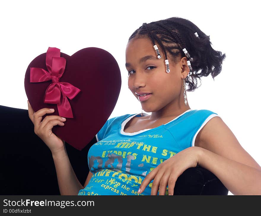 A cute young girl smiling and holding a heart. A cute young girl smiling and holding a heart