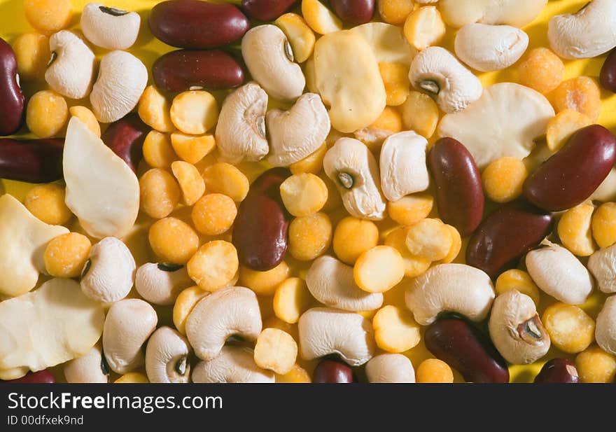 Variety of beans on a yellow backgound