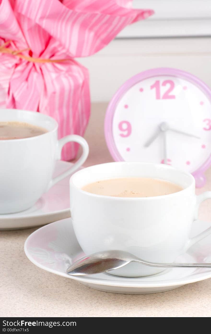 Cups of coffee and a clock in the background. Cups of coffee and a clock in the background.