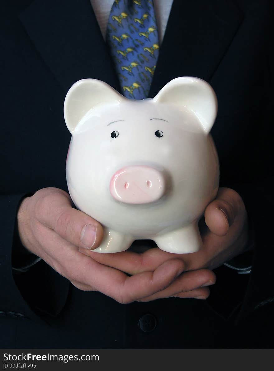 Businessman Holding A Piggy Bank