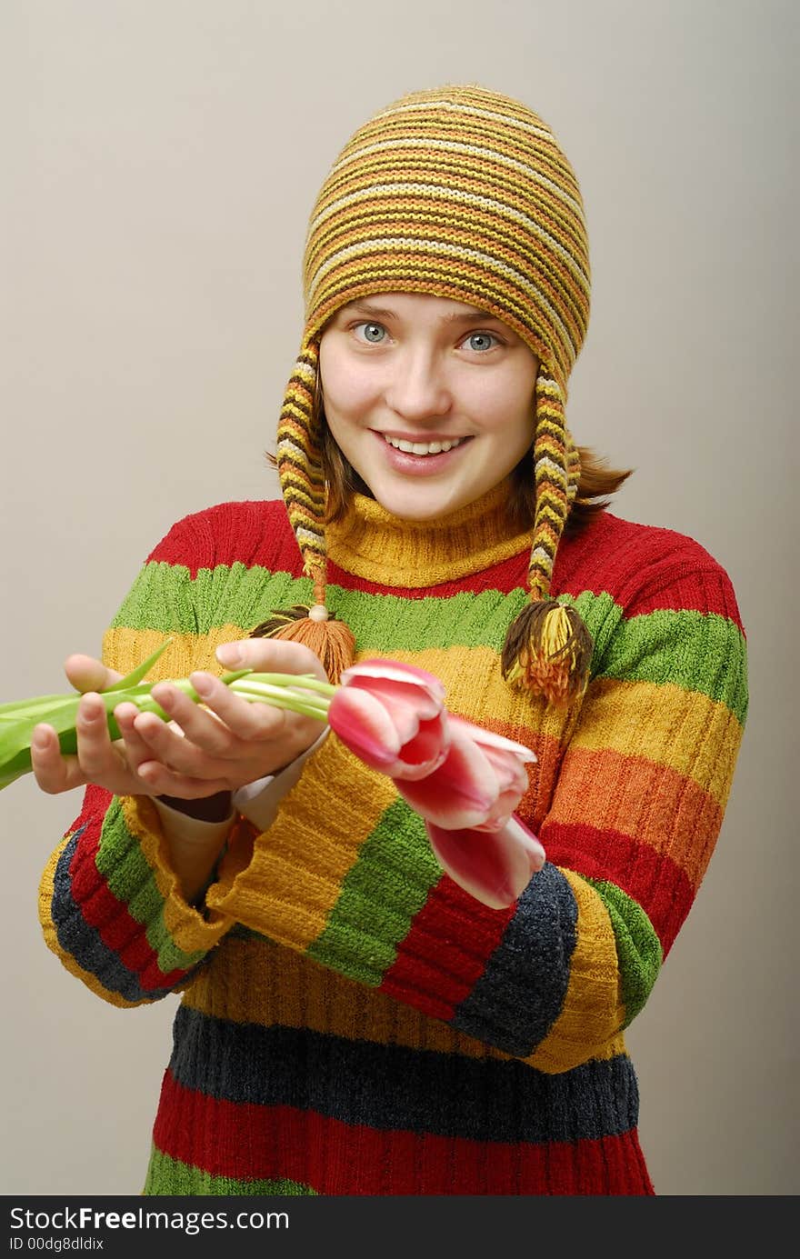 Girl with blue clear eyes holds tulips. Girl with blue clear eyes holds tulips