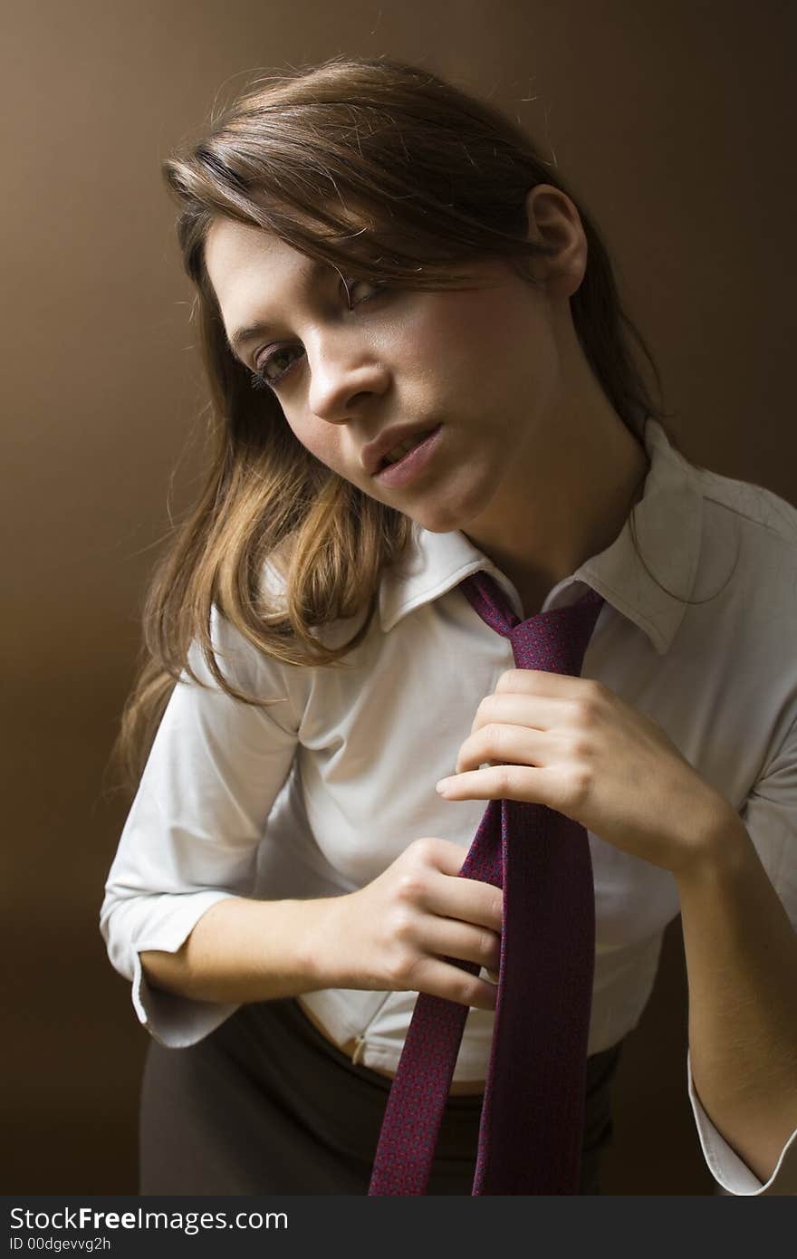 Women at work: irritated businesswoman fixing her tie. Women at work: irritated businesswoman fixing her tie