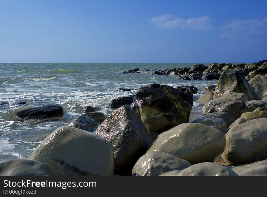 Rugged seashore rocks and horizon with dark blue skies. Rugged seashore rocks and horizon with dark blue skies