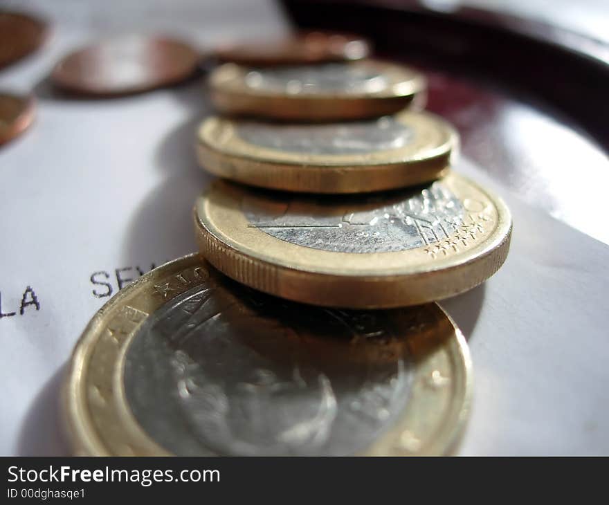 Some coins over the bill in a restaurant. Some coins over the bill in a restaurant