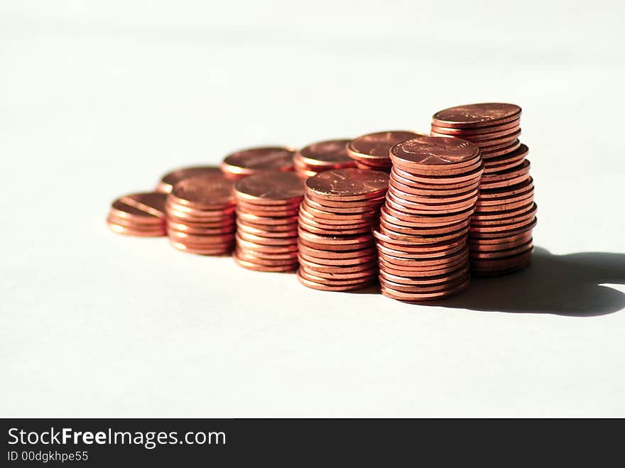 Stacks of pennies against a white background. Stacks of pennies against a white background