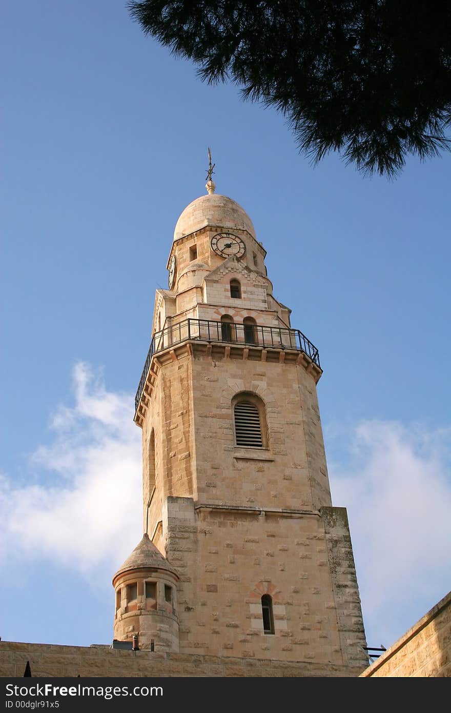 Dormition Abby (Benedictine Basilica of the Dormition) watch tower in Jerusalem. The Dormition Abbey is a massive structure, just outside the Zion Gate, and resembles a mighty fortress; it is topped by a high, domed belltower, a conical dome and corner towers. Dormition Abby (Benedictine Basilica of the Dormition) watch tower in Jerusalem. The Dormition Abbey is a massive structure, just outside the Zion Gate, and resembles a mighty fortress; it is topped by a high, domed belltower, a conical dome and corner towers.